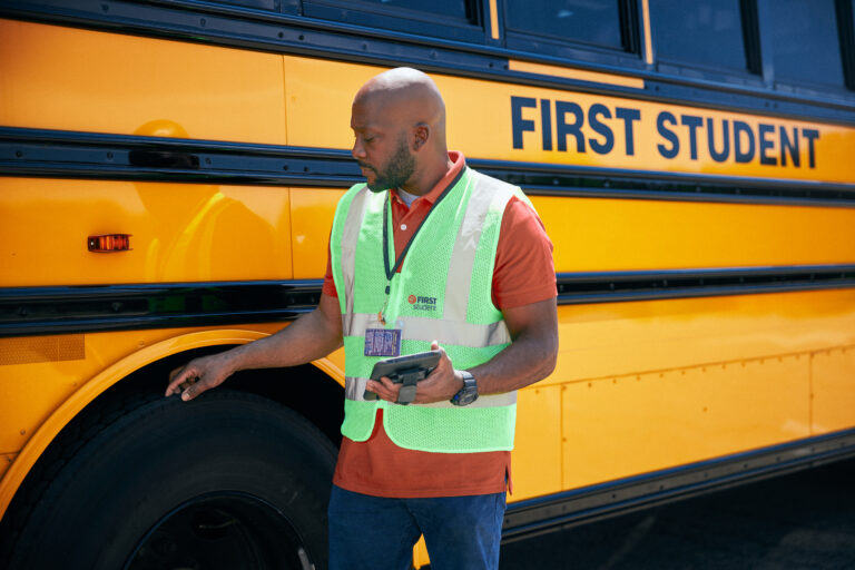 Driver Inspecting Bus