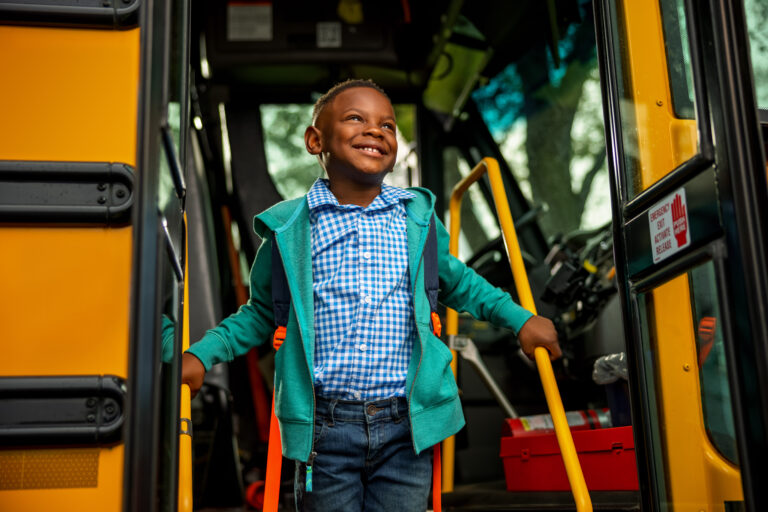 First_Student_Chil_Getting_Off_Bus_Safe_Ride.jpg