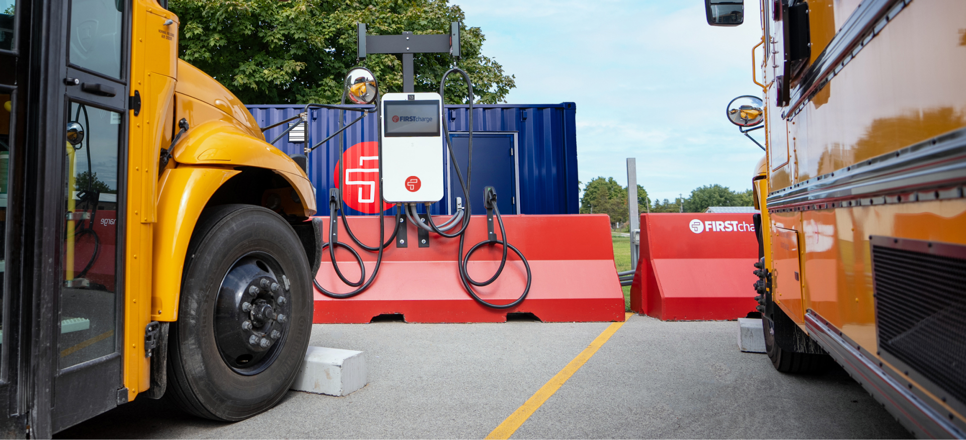 Electric buses parked next to an electric charger