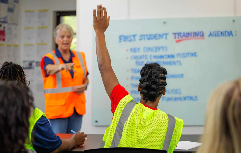 A First Student employee answering a question from a First Student trainee